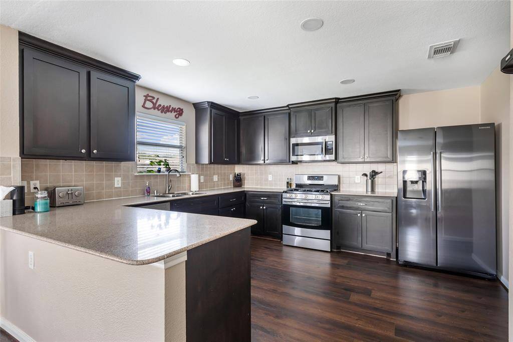 Breakfast bar will host a couple of barstools for a quick snack or a spot for homework. Love the U-shaped kitchen!