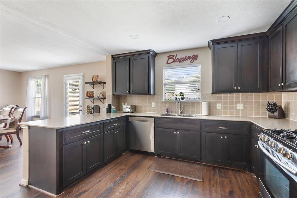 Updated cabinets, tile backsplash and stainless steel appliances. Also a view to the back yard to keep an eye on things.