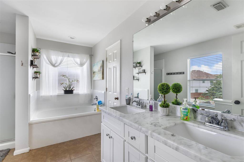 Updated cabinets, granite counters and double sinks ins the owner's retreat. Jacuzzi tub for relaxing bubble baths. and separate shower.