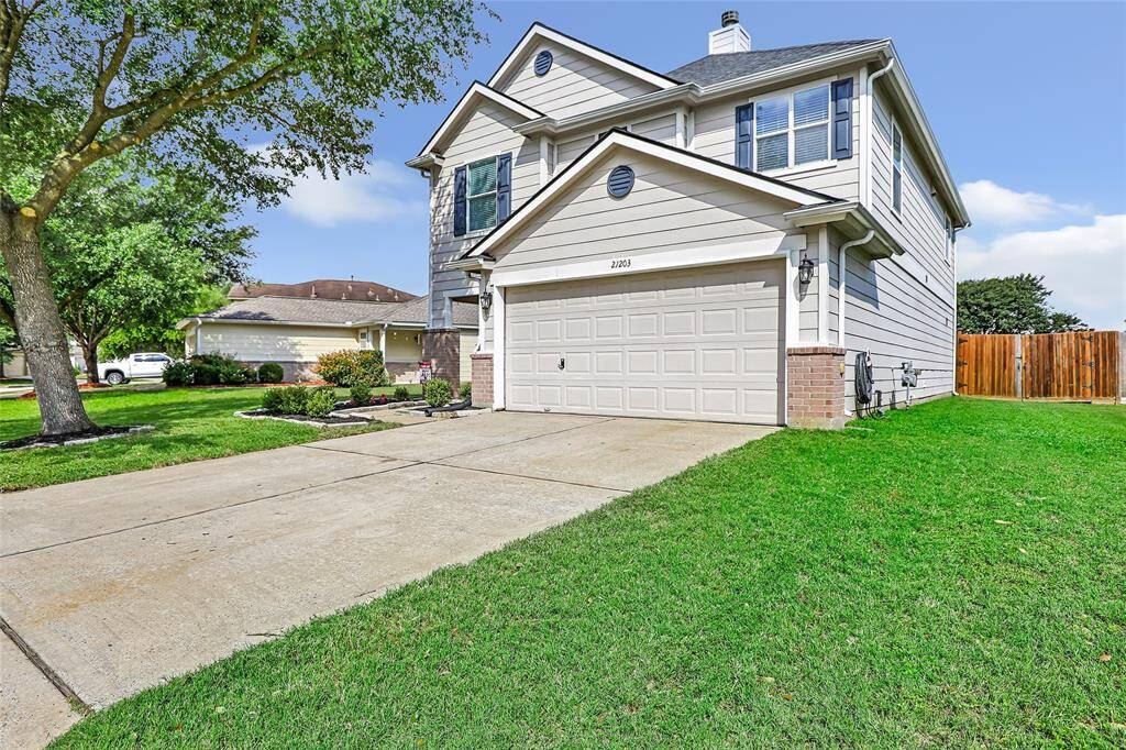 Double wide driveway provides ample parking for guests.