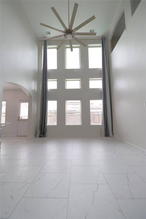 Vaulted living room with tons of natural light looking out to your pool.