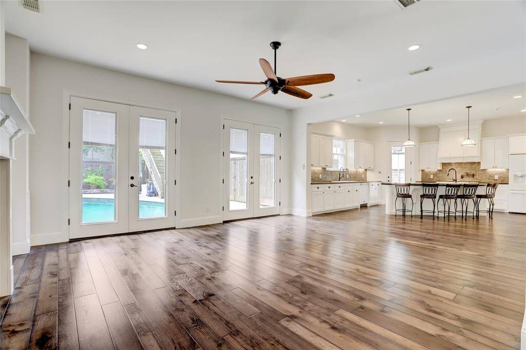 Another view of the amazing living room  with French doors overlooking the pool