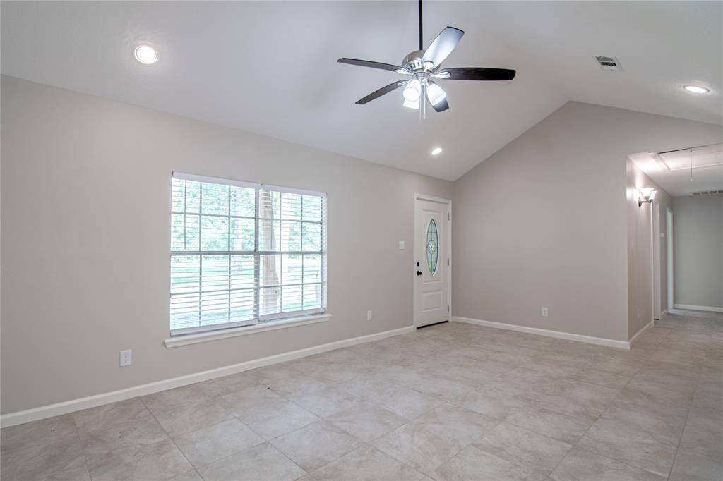 Another view of the living room and front door.