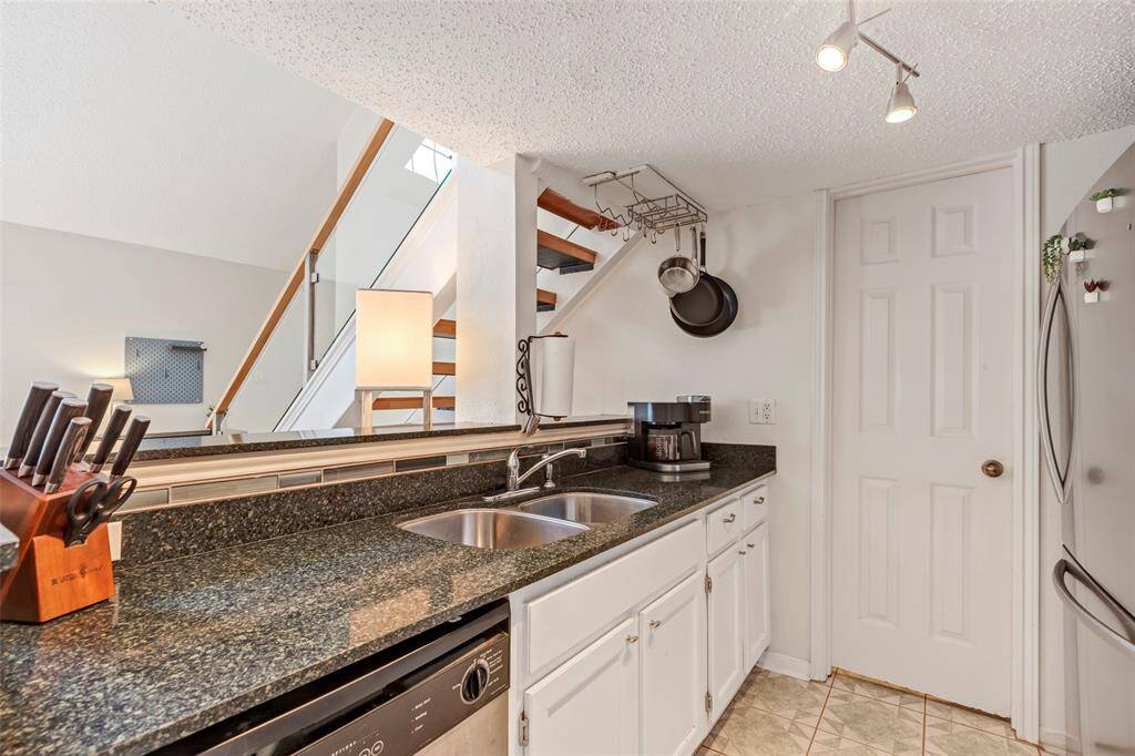 Modern kitchen with sleek granite countertops.