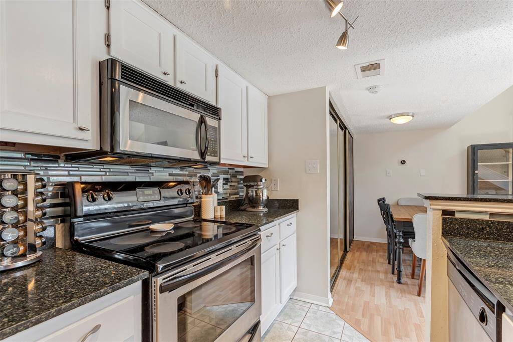 Fully equipped kitchen featuring an electric oven and microwave seamlessly integrated into the cabinetry.