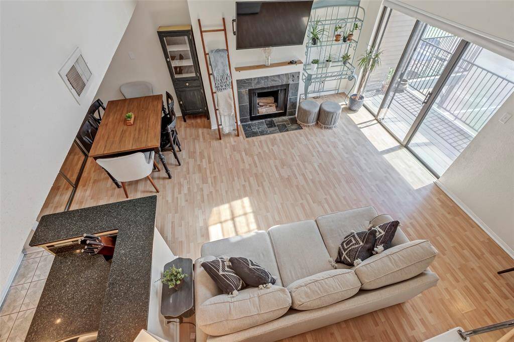Sun-drenched living room with expansive glass sliding doors, creating a bright and inviting atmosphere.