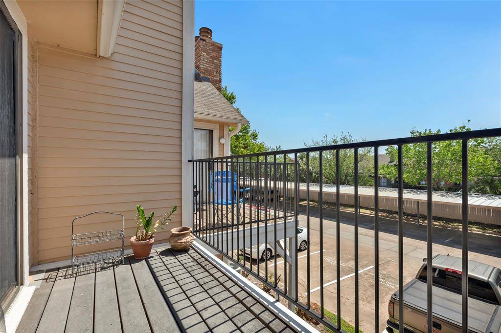 Step onto the terrace and enjoy a view overlooking the neighborhood's resident parking area, offering a unique perspective of the community.