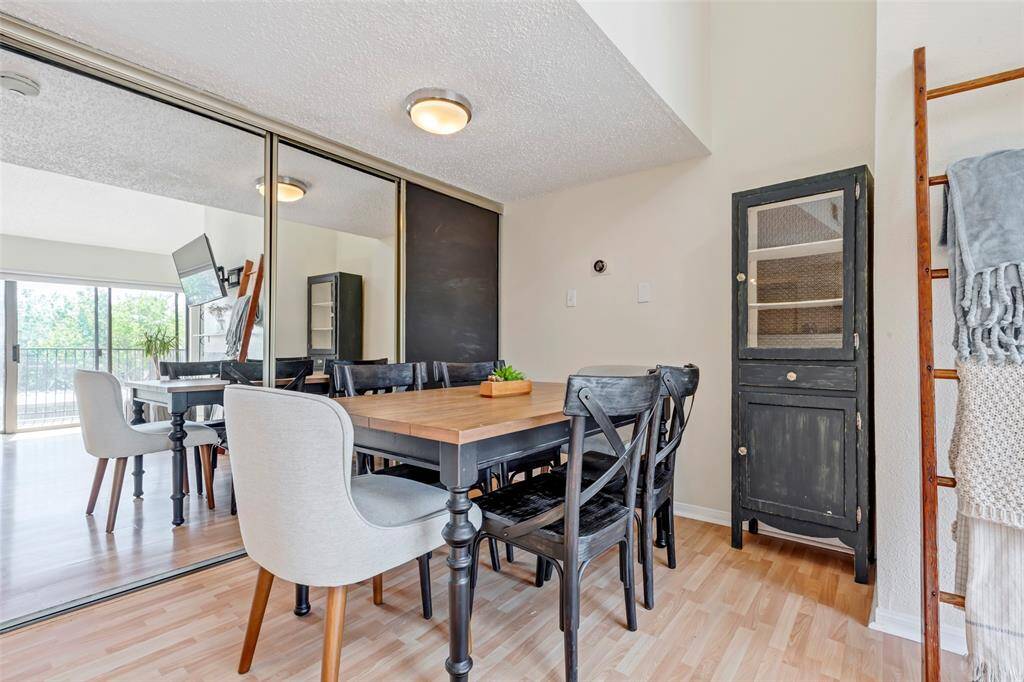 Charming dining area with a stylish wall mirror reflecting the space.