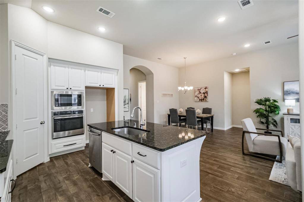 Corner, walk in pantry and sinkin the island.
