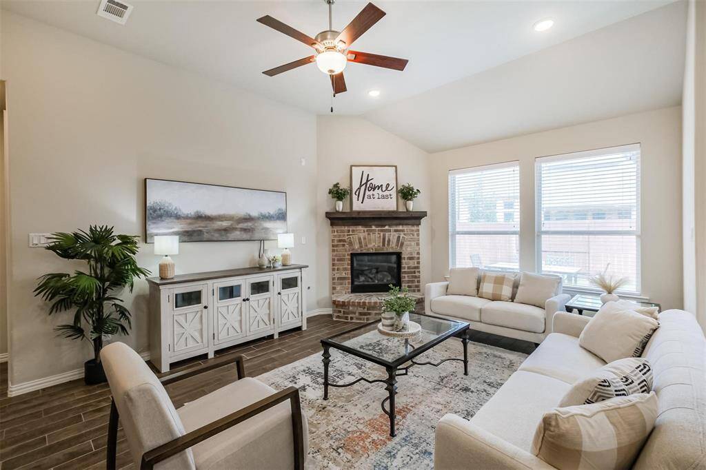Living room with corner gas logfireplace.