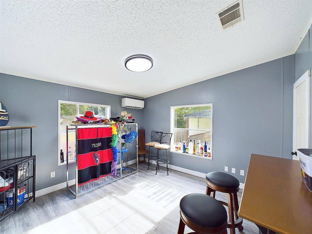 Back Bedroom 3 used as an entertainment space with a passthrough window to out back
