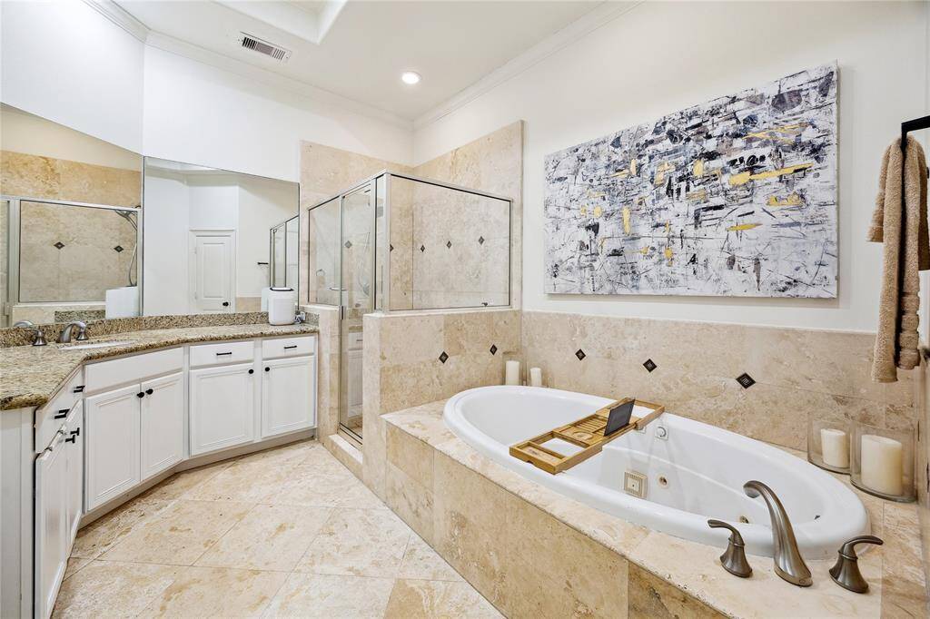 The primary bathroom has granite countertops  and two sinks.