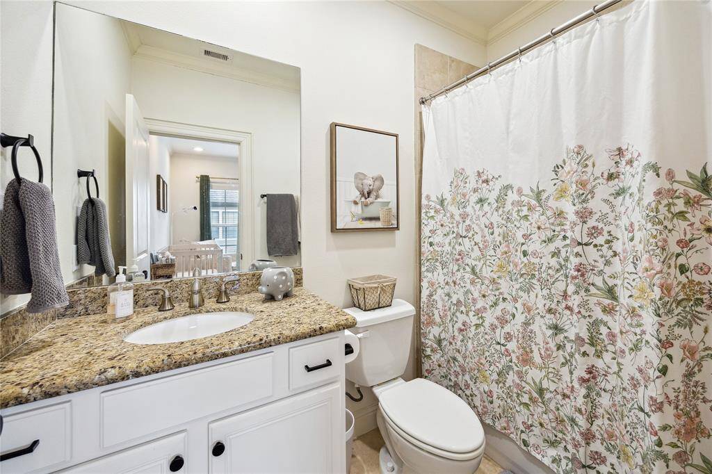The bathroom has a tub/shower combo and granite countertops.