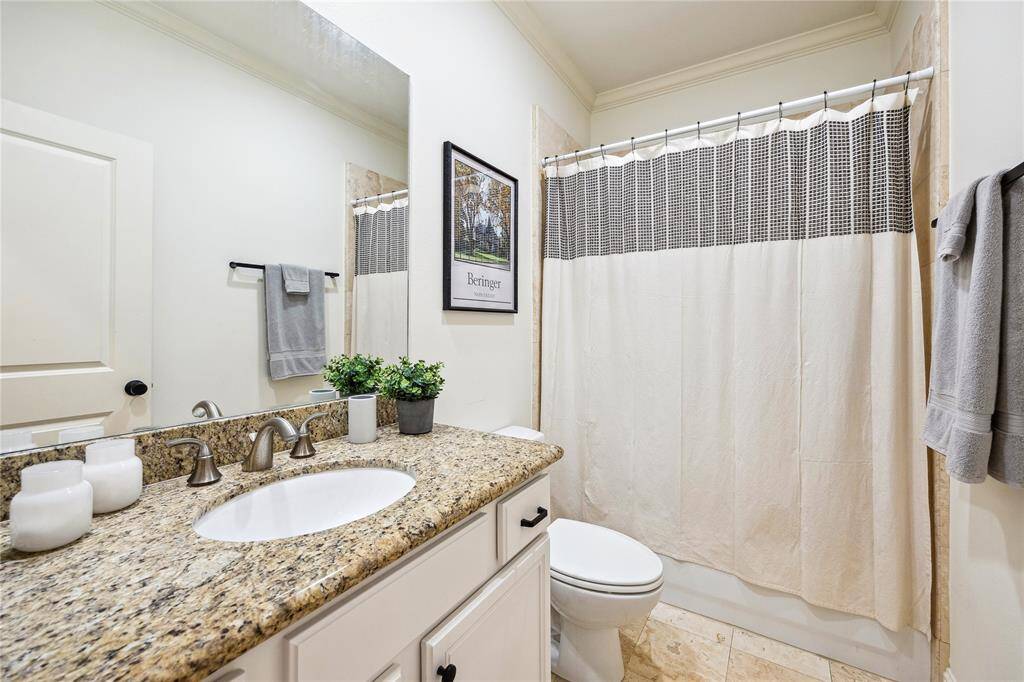 The first floor bathroom has a tub/shower combo and granite countertops.