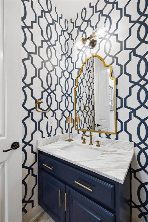 Sleek and modern half bath tucked at the base of the stairs