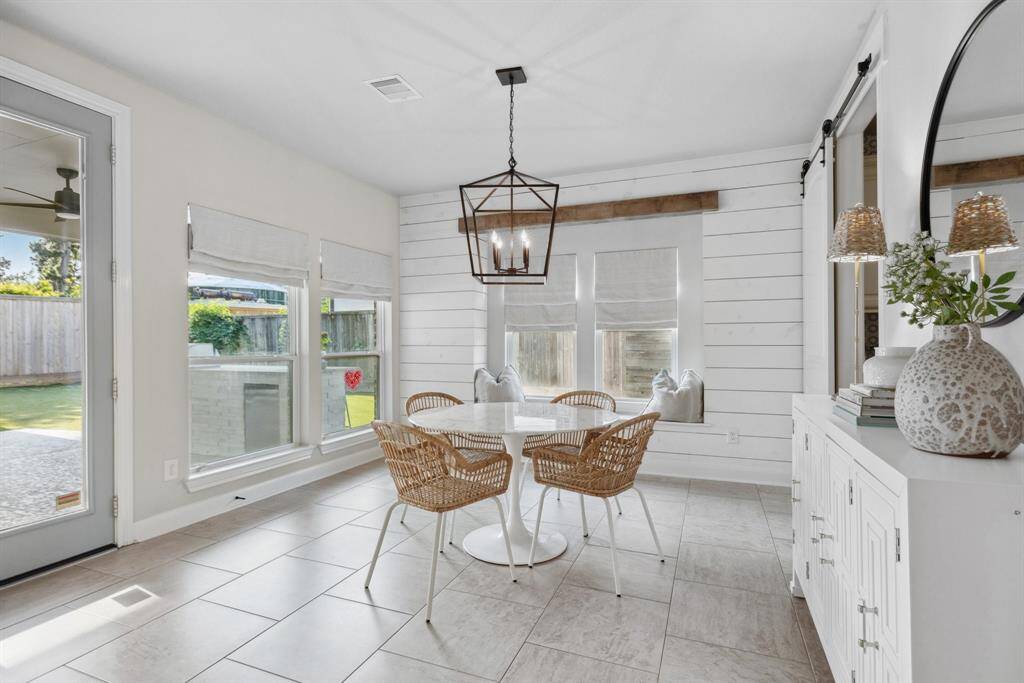 Window seat with shiplap surround in the bright breakfast room/sunroom