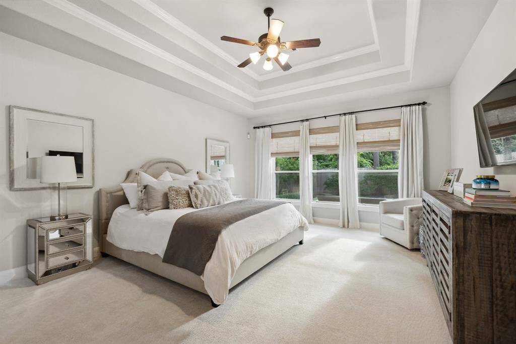Oversized primary bedroom with double tray ceiling