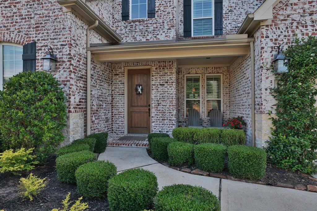 Lush Carnahan landscaping leading to front door