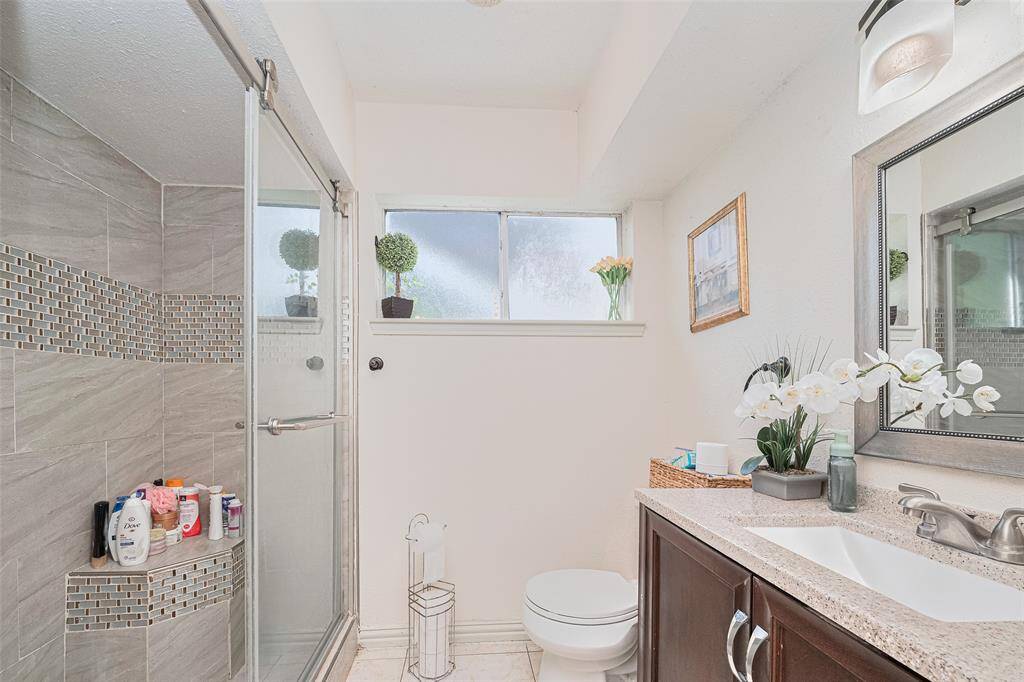 Solid surface counters, window for natural light, tiled shower with built in seating