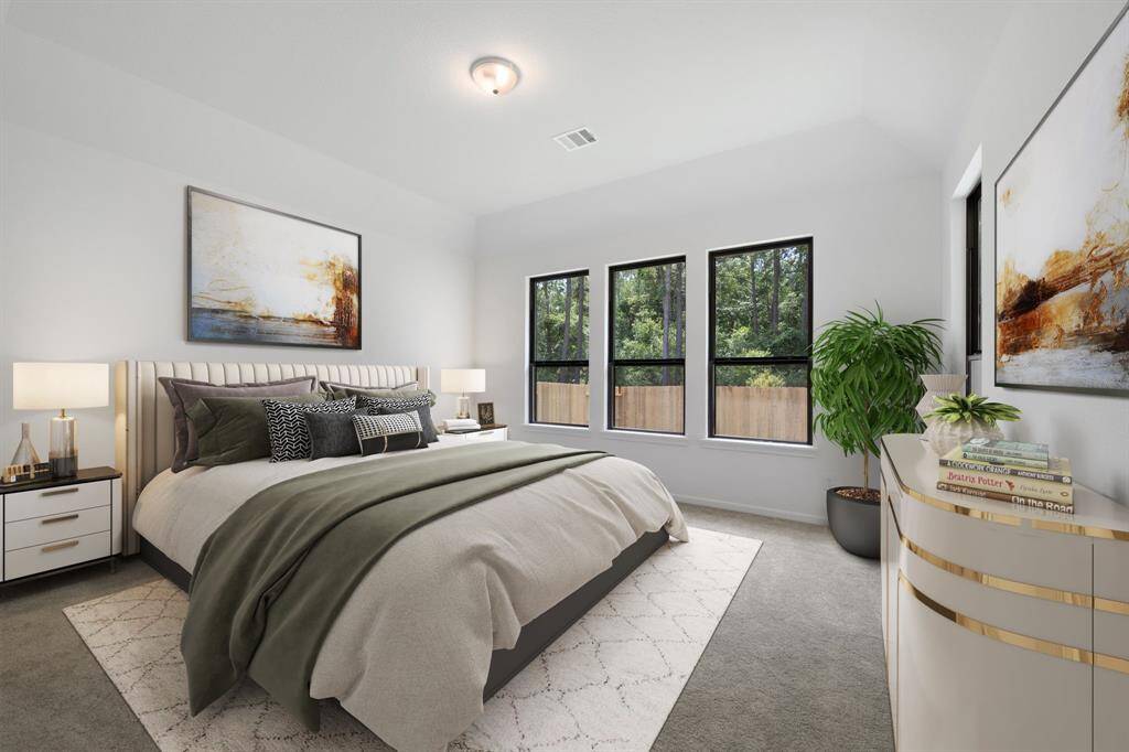The primary bedroom is generously sized, creating a tranquil and spacious retreat that offers ample room for relaxation. Featuring plush carpet, high ceilings, fresh paint, and large windows that lets in natural lighting throughout the day.