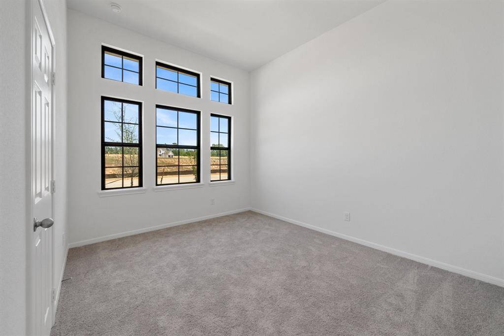 Your secondary bedroom features plush carpet, fresh paint, closet, and a large window that lets in plenty of natural lighting.