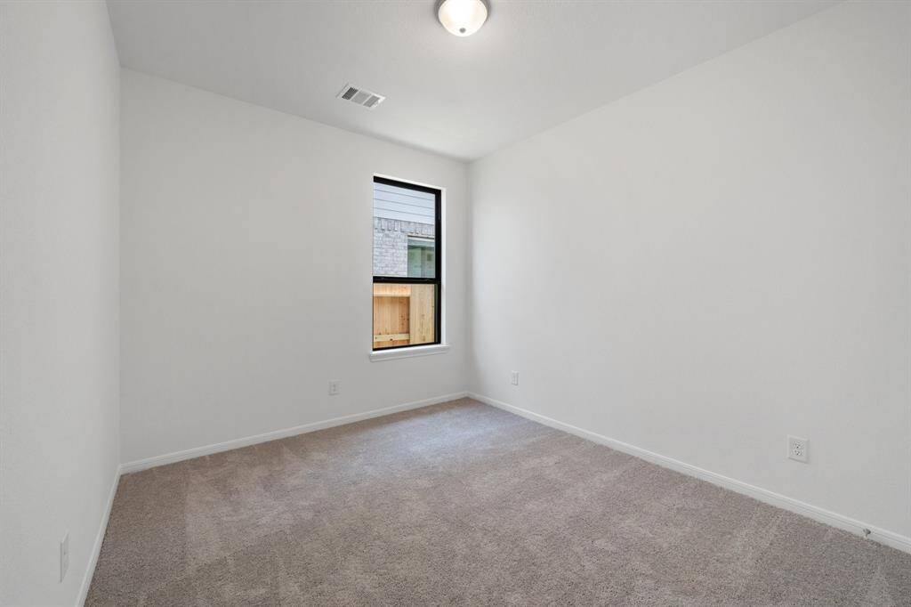 Your secondary bedroom features plush carpet, fresh paint, closet, and a large window that lets in plenty of natural lighting.