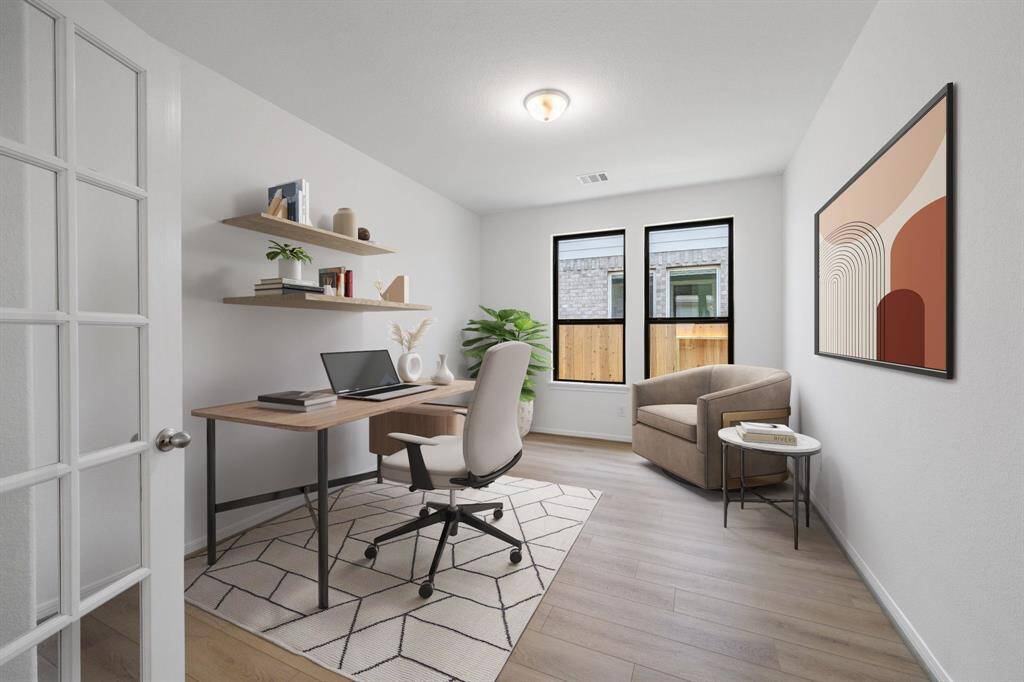 The home office features French doors, beautiful floors, large windows that give a fresh feel, this space promotes focus and creativity.
