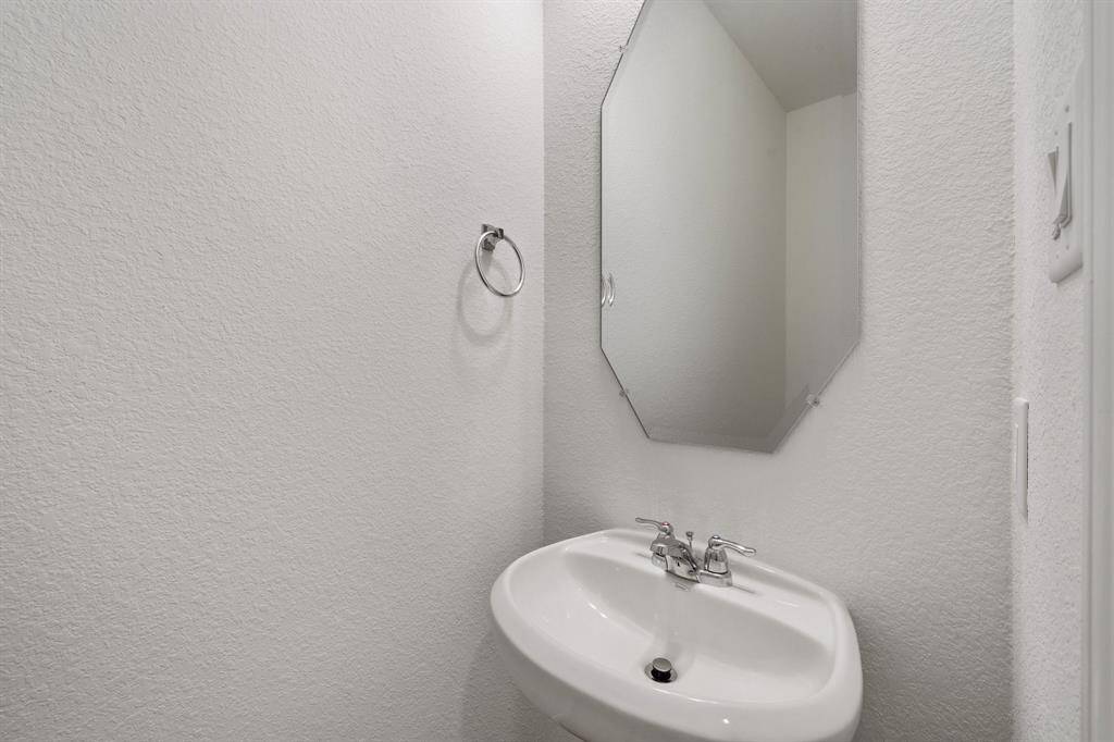 This charming home features a beautifully appointed half bath adjacent to the family room, perfect for welcoming guests and adding convenience to your daily life.
