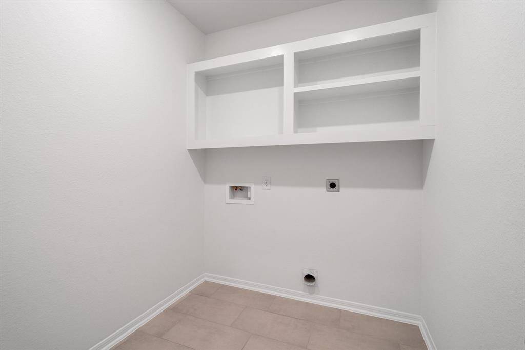 The laundry room layout is carefully planned for optimal workflow with designated areas for washing, drying, and storing.