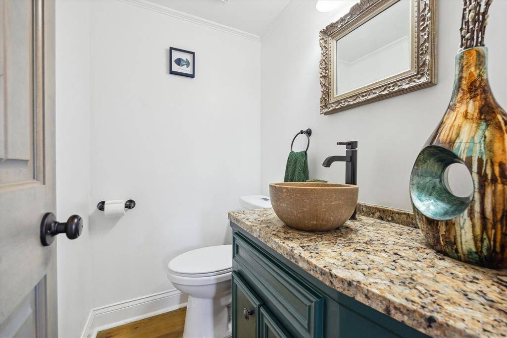 The powder room is just between the living and dining rooms