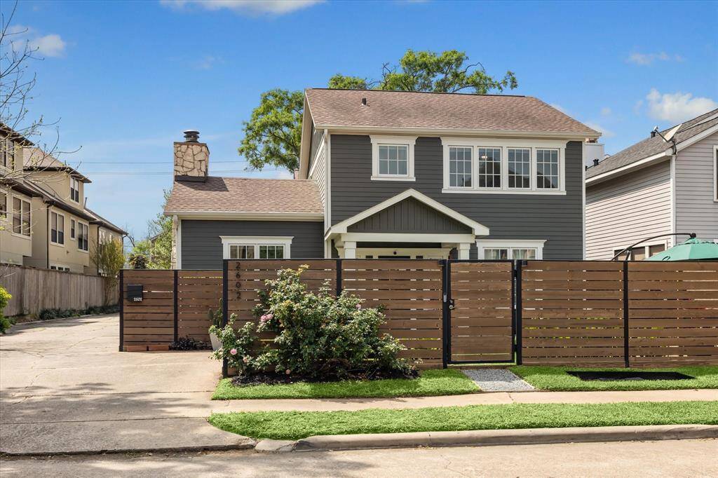 This charming two-story home features a modern gray exterior and white trim, prominent stonechimney and a welcoming front porch. The sleek wooden fence offers privacy, while the neatly landscaped front yard adds curbappeal. Ideal for those seeking a stylish and cozy residence.