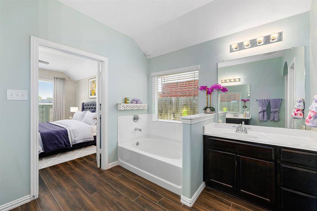 This additional view of the primary bath showcases the separate garden tub perfect for soaking after a long day.