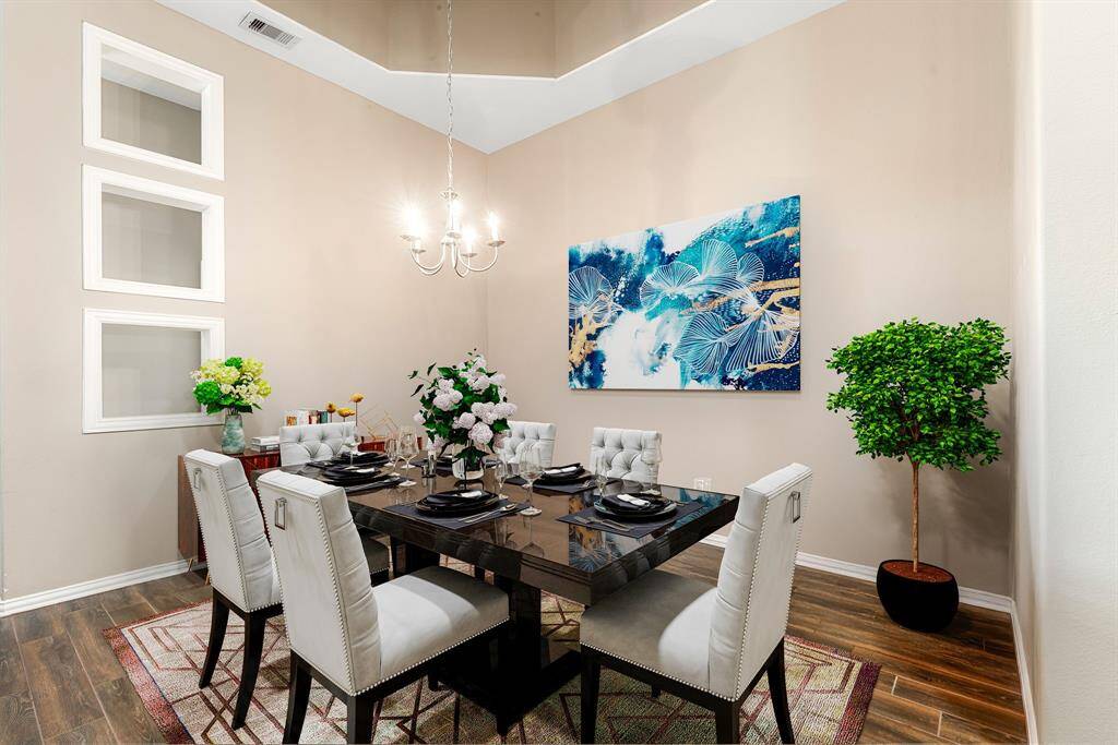 Make memories gathered around the table with your family and friends! This dining room features high ceilings, wood style floors, and a beautiful chandelier. *Virtally Staged