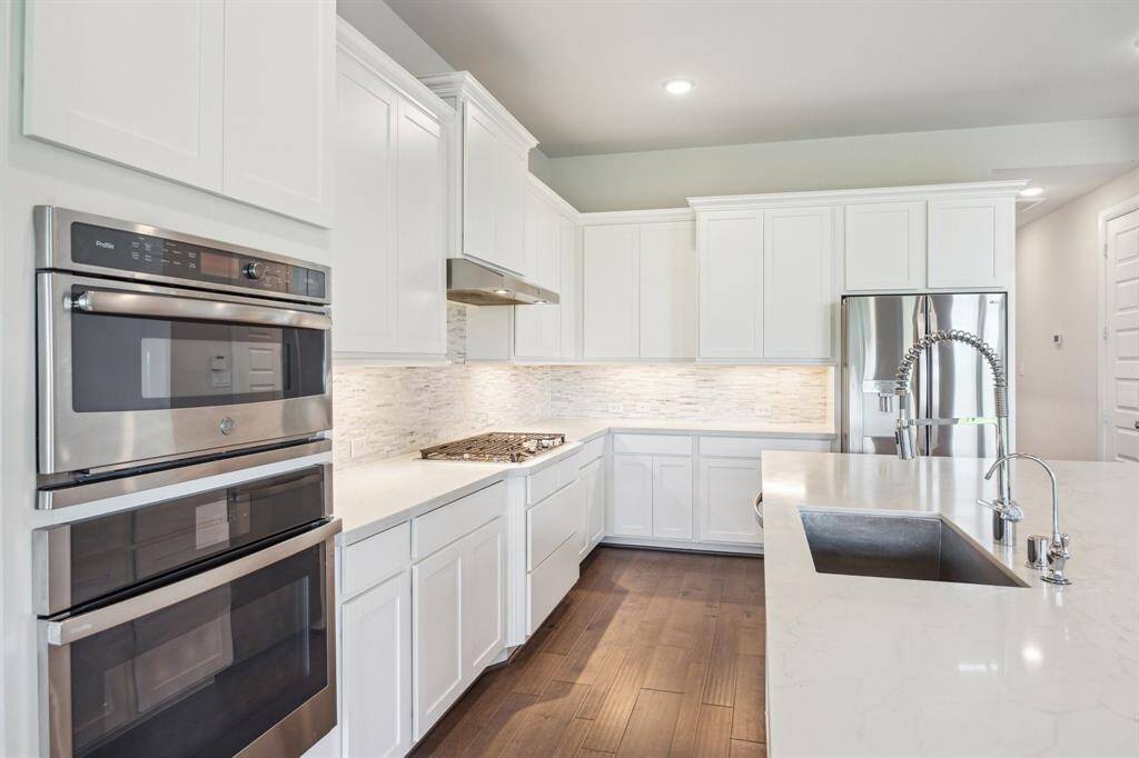 This classic designed kitchen blends elegance and practicality, featuring neutral granite countertops beautifully paired with upgraded backsplash, ample counter space for meal preps and a well-integrated custom surround for the fridge.  Whether preparing gourmet meals or hosting lively gatherings, this kitchen offers an inviting atmosphere that caters to both everyday comforts and grand entertaining.