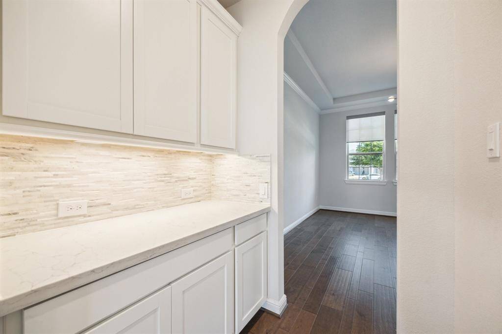 The conveniently situated Butler’s Pantry is designed for entertaining, offering both style and practicality. Perfectly placed to streamline hosting, it provides ample storage and prep space for serving drinks, appetizers, or desserts with ease. Whether preparing for an intimate dinner or a grand celebration, this thoughtfully designed feature enhances the flow of gatherings, ensuring every event is both seamless and memorable.