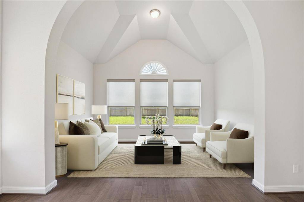The primary sitting area exudes elegance with its striking ceiling design and expansive windows, creating an atmosphere of grandeur and comfort. Natural light pours in, illuminating the space and accentuating its architectural beauty. Whether enjoying quiet moments of relaxation or taking in the scenic views, this refined retreat offers the perfect balance of sophistication and tranquility within the primary space.