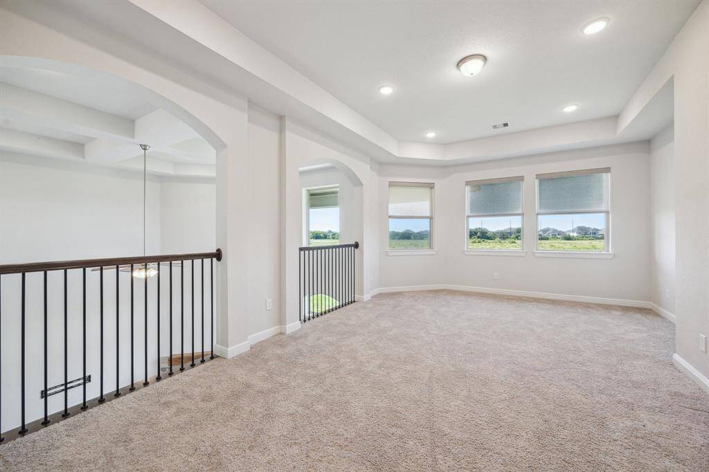 This spacious game room overlooks the family room below and has incredible natural light and gorgeous views of the greenery beyond.  It offers plenty of room for fun, and memorable family moments. Whether hosting game nights, enjoying movie marathons, or creating the perfect play area, this versatile space adapts to every occasion. With ample space to accommodate future adventures, this game room ensures that fun and relaxation are always just a step away!
