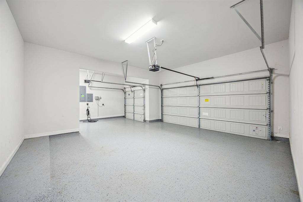 This impressive upgraded three-car garage offers generous space, not just for vehicles but for all your storage and hobby needs.  With plenty of room for cars, bikes, and even a potential home gym, this versatile space invites the future homeowner to customize it to suit their lifestyle. Whether it’s for parking, fitness, or organization, this garage delivers both convenience and flexibility in one spacious package.