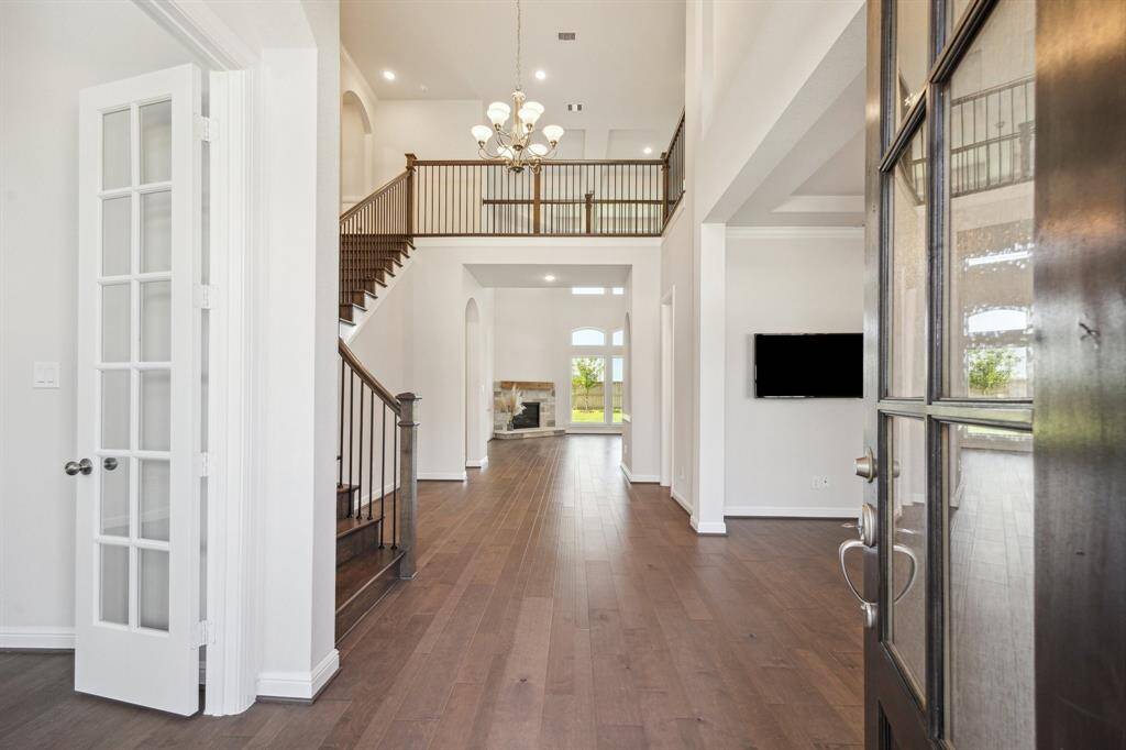 The entrance into the grand foyer is nothing short of breathtaking, making an unforgettable first impression. With soaring ceilings, elegant architectural details, and an inviting ambiance, this space sets the tone for the rest of the home. Whether welcoming guests or simply arriving home each day, the grandeur of the foyer creates a sense of warmth and sophistication that leaves a lasting impact.