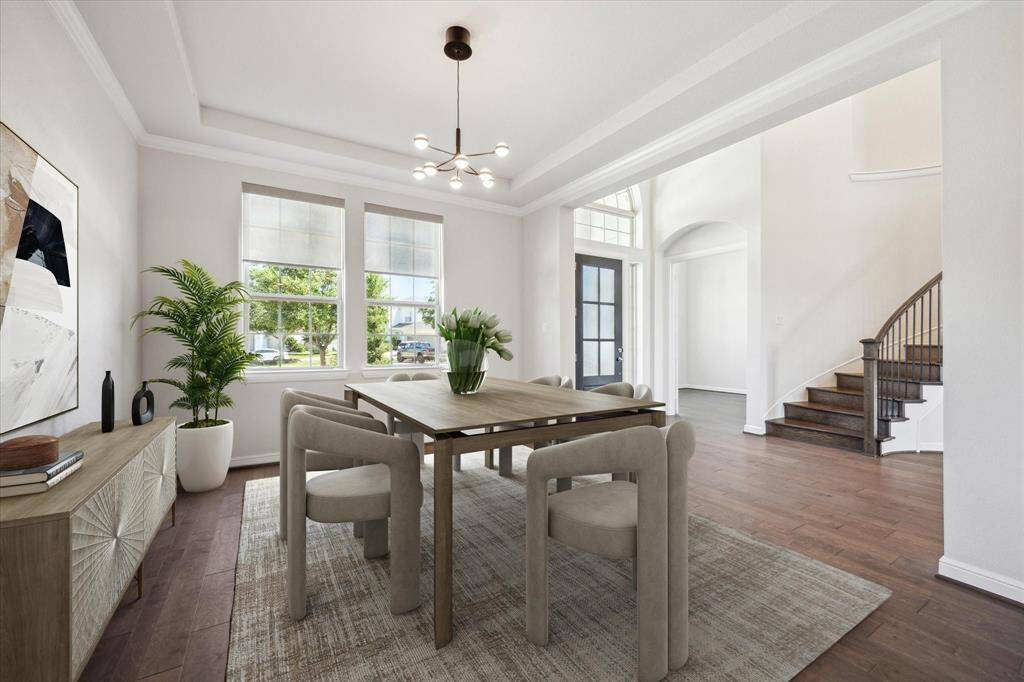 Imagine hosting unforgettable holiday gatherings in this spacious formal dining room open to the grand foyer.  With ample space for festive décor and cherished traditions, this elegant space is the perfect setting for creating memories.  Engineered wood floors add warmth throughout the first floor, upgraded coffered ceilings and crown molding add a level of architectural detail to this elegant home.