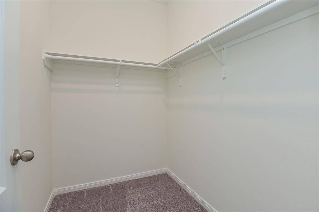 WALK-IN CLOSET IN PRIMARY BEDROOM