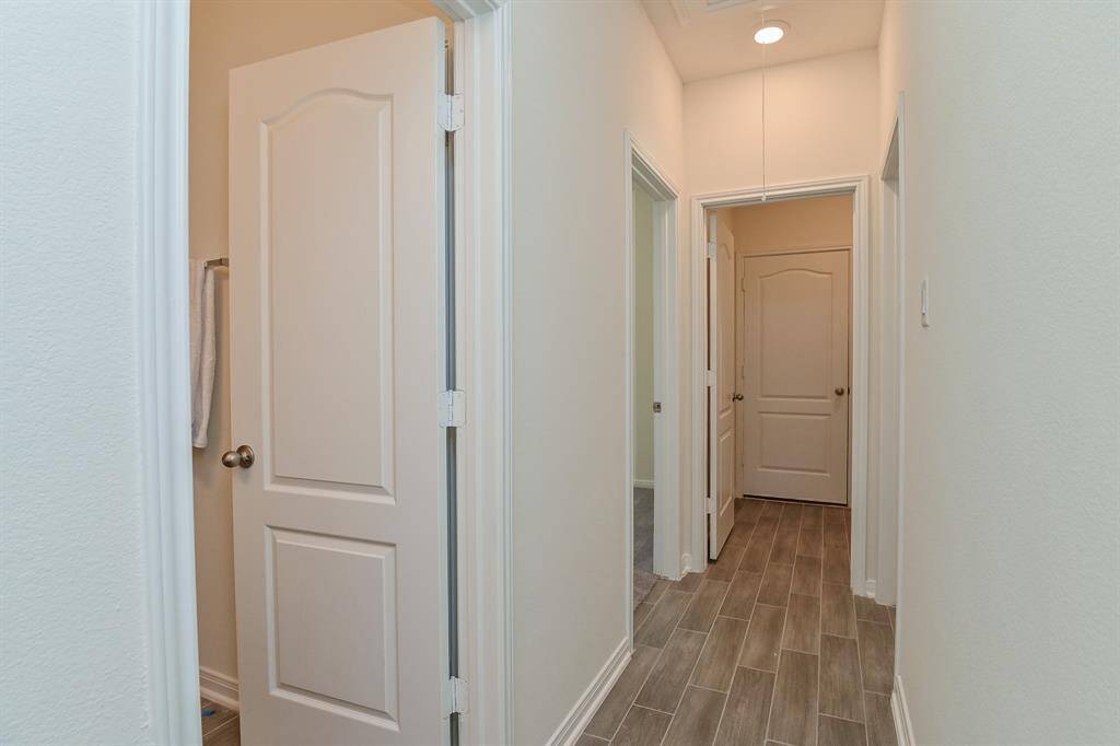 HALLWAY TO GUEST BATH AND ADDITIONAL TWO BEDROOMS