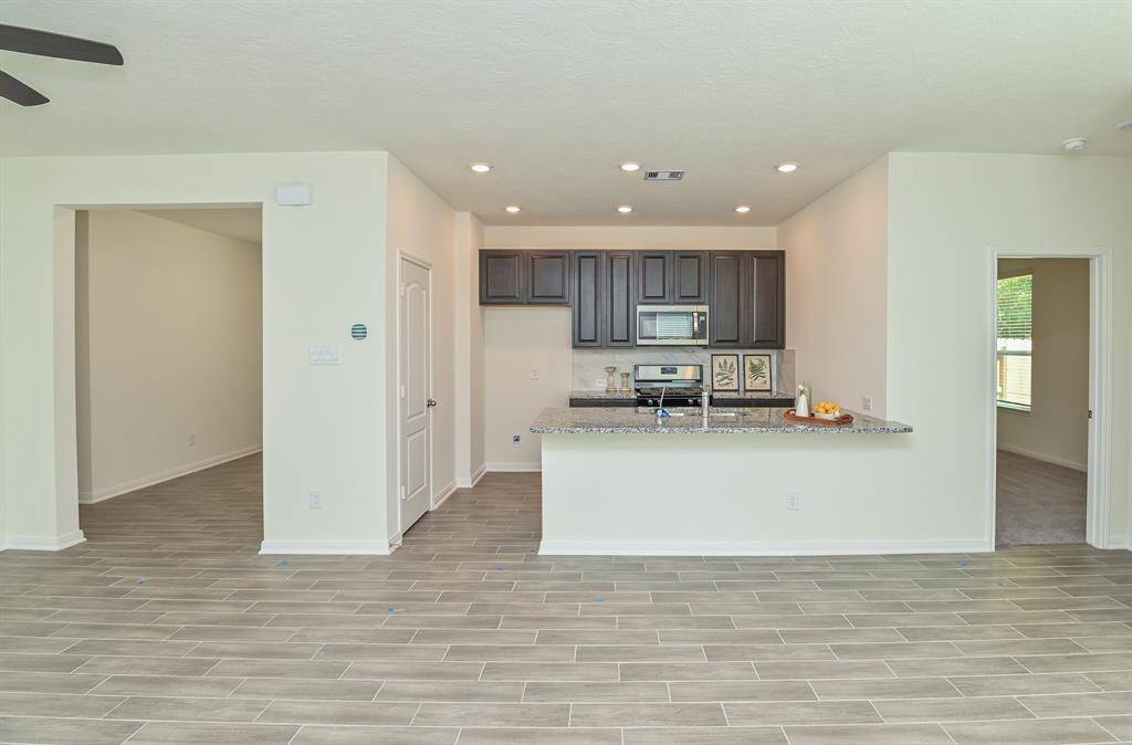 KITCHEN OPEN TO THE LIVING & DINING ROOM (You can see the study on left side & primary bedroom on right side.)