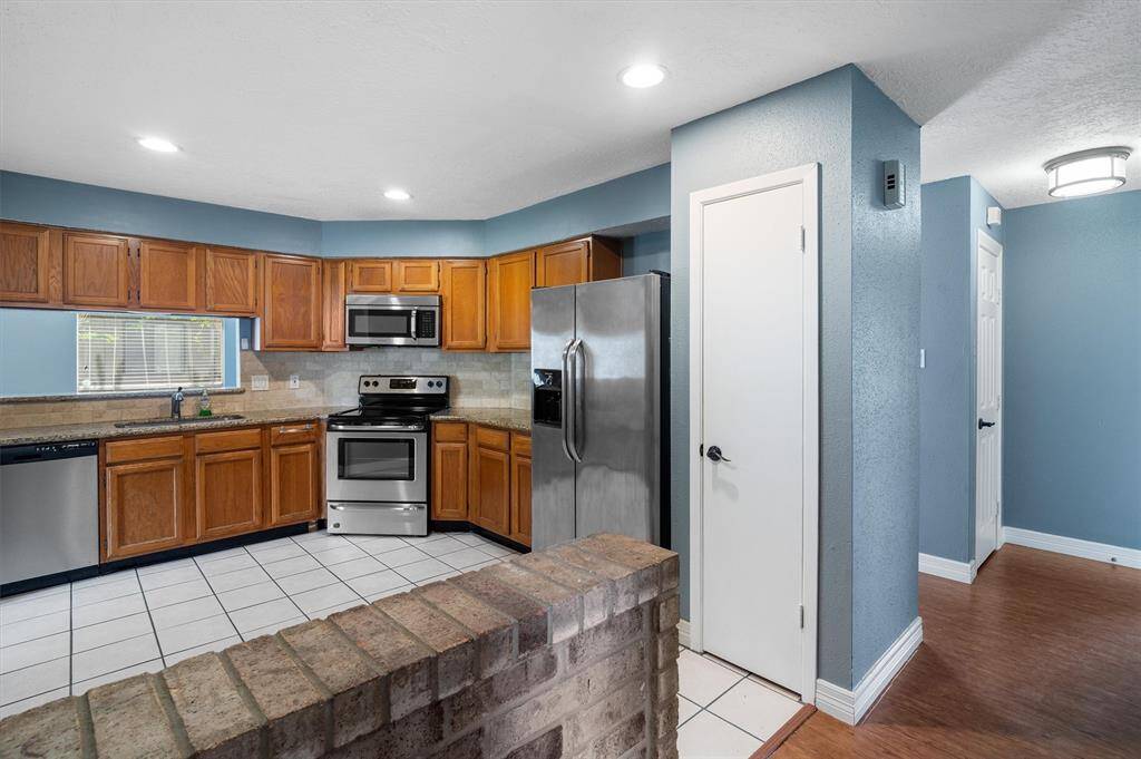 Kitchen featuring stainless steel appliances and granite countertops