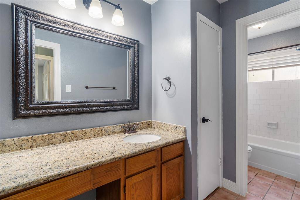 Second full bath with additional counter space and framed mirror