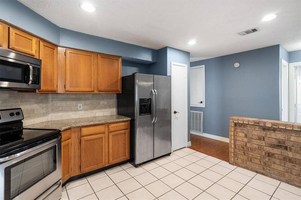 Stainless steel appliances and granite countertops in the kitchen