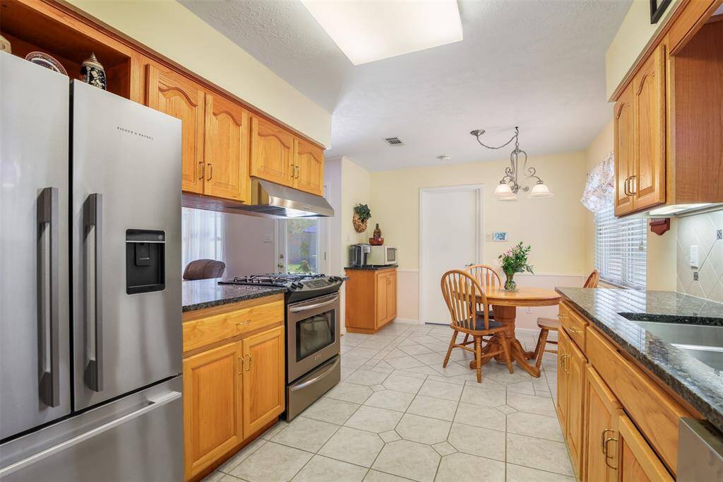 Kitchen also has black granite counter tops and under-mount large stainless steel sink.