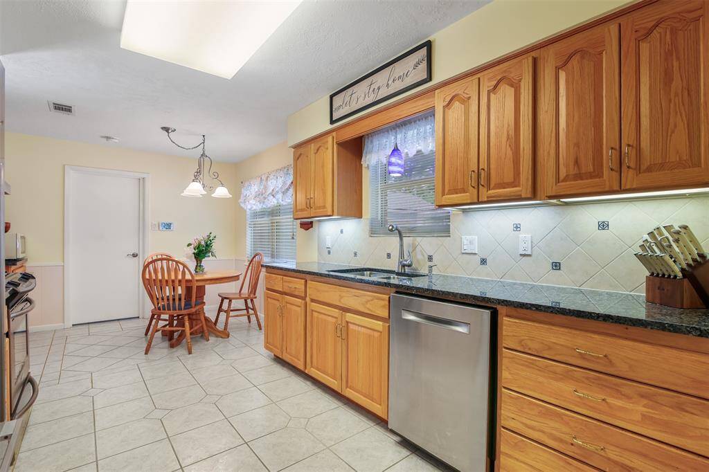 The kitchen has matching ss appliances and lots of storage space. Tile backsplash and under cabinet lighting are a few other features.