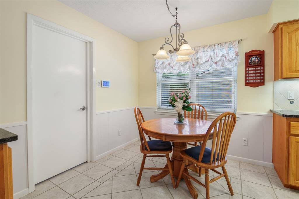 The breakfast room has tile floors, picture window and access to the garage.