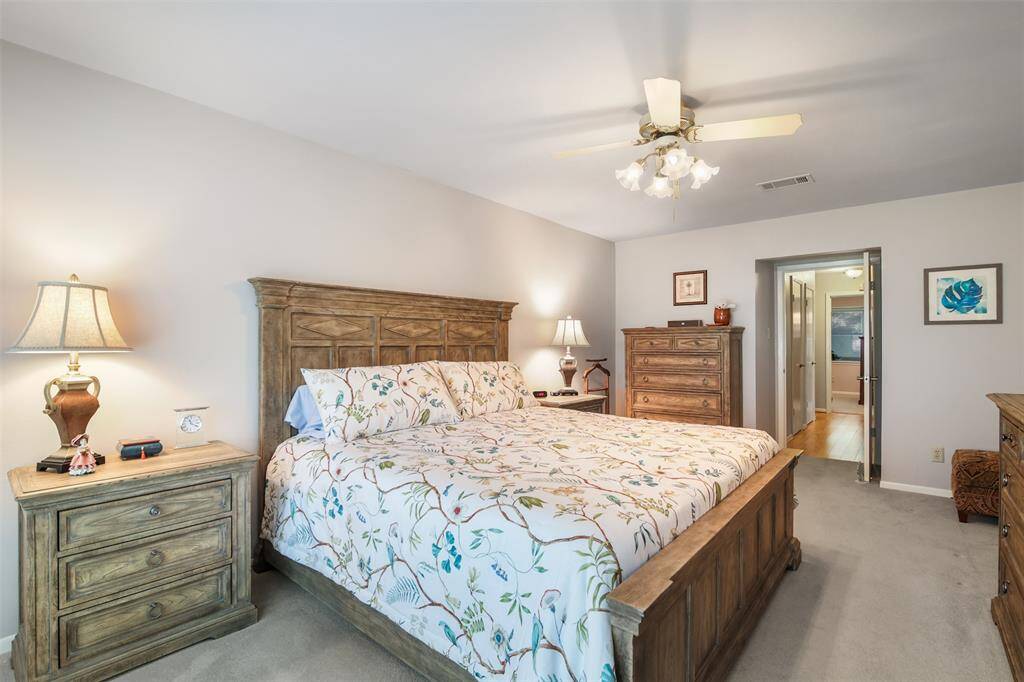 Another view of the primary bedroom which is at the end of the hallway and has an ensuite bathroom.